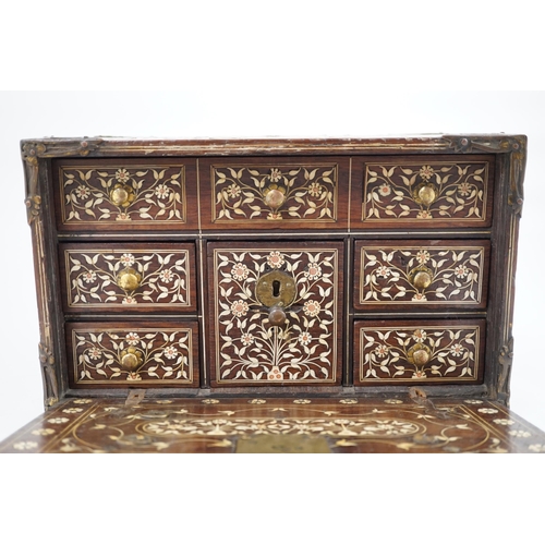 42 - An early 17th century Indo-Portuguese ivory inset hardwood travelling chest with brass loop handles,... 