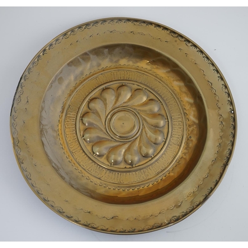 43 - A 16th century German brass alms dish, Nuremberg, circa 1550, with stylised foliate banding and rubb... 