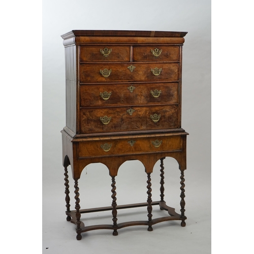 44 - An early 18th century walnut chest on stand with cushion frieze drawer over two short and three grad... 