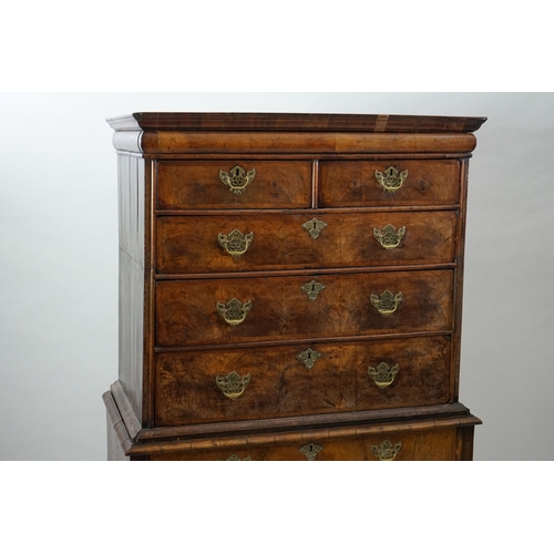 44 - An early 18th century walnut chest on stand with cushion frieze drawer over two short and three grad... 