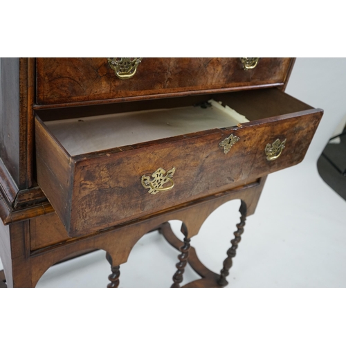 44 - An early 18th century walnut chest on stand with cushion frieze drawer over two short and three grad... 