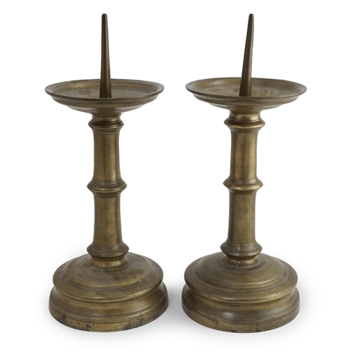 45 - A pair of 16th century bell metal pricket candlesticks with ring turned stems and feet, 16cm diamete... 