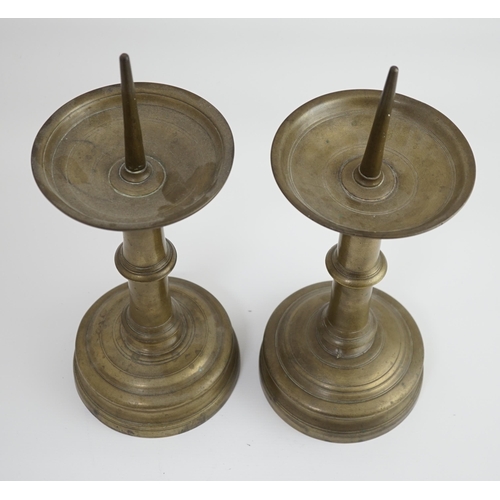 45 - A pair of 16th century bell metal pricket candlesticks with ring turned stems and feet, 16cm diamete... 