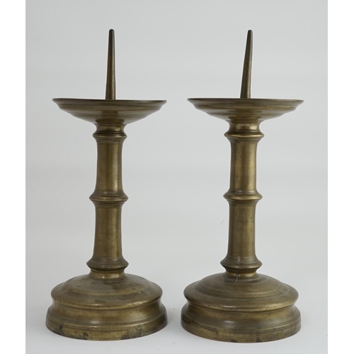 45 - A pair of 16th century bell metal pricket candlesticks with ring turned stems and feet, 16cm diamete... 