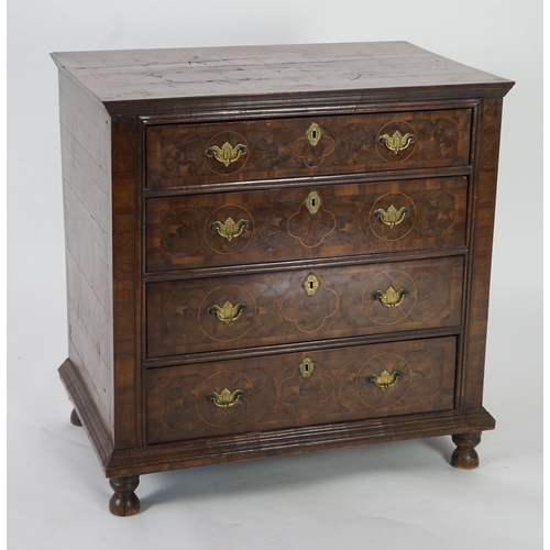 46 - A William and Mary oyster veneered laburnum and walnut chest of four long drawers, with geometric st... 