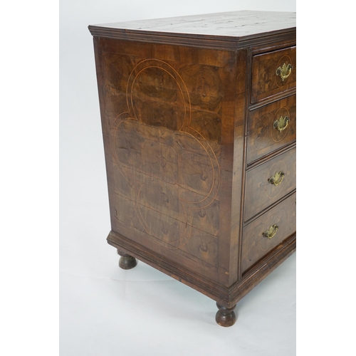 46 - A William and Mary oyster veneered laburnum and walnut chest of four long drawers, with geometric st... 