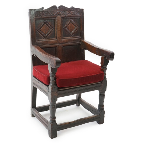 48 - A 17th century and later oak Wainscot elbow chair with quadruple panelled back and solid seat, on tu... 