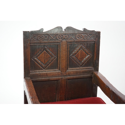 48 - A 17th century and later oak Wainscot elbow chair with quadruple panelled back and solid seat, on tu... 