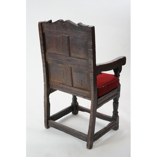 48 - A 17th century and later oak Wainscot elbow chair with quadruple panelled back and solid seat, on tu... 