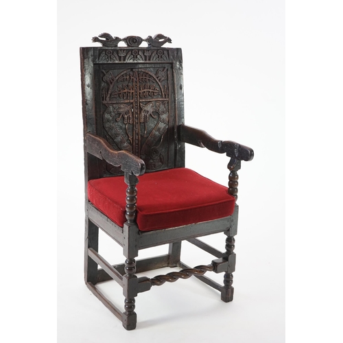 49 - A 17th century and later Yorkshire oak Wainscot elbow chair, the panelled back carved with stylised ... 