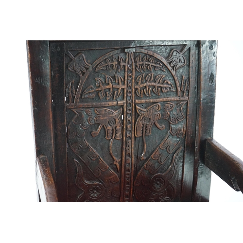 49 - A 17th century and later Yorkshire oak Wainscot elbow chair, the panelled back carved with stylised ... 