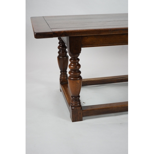 5 - A 17th century style oak refectory table with cleated planked top on turned baluster and squared all... 