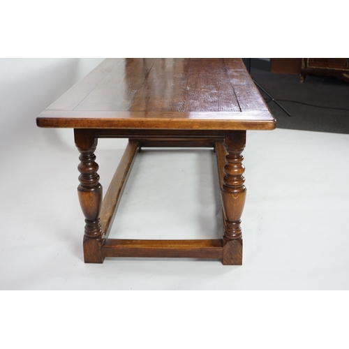 5 - A 17th century style oak refectory table with cleated planked top on turned baluster and squared all... 