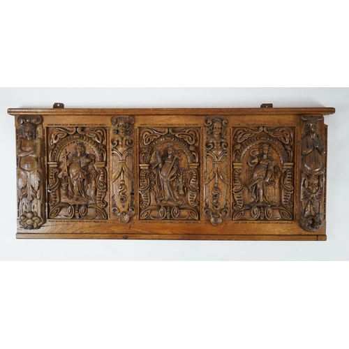 52 - A 17th century and later Flemish carved oak panel with three arched sections carved with the three v... 