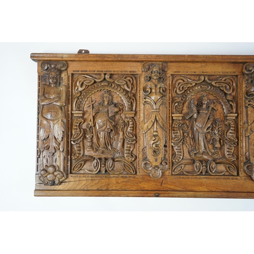 52 - A 17th century and later Flemish carved oak panel with three arched sections carved with the three v... 