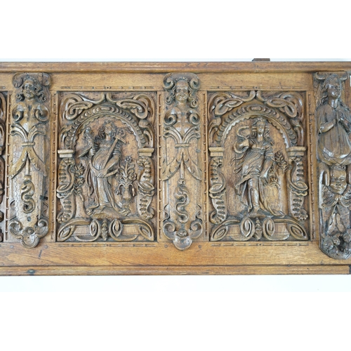 52 - A 17th century and later Flemish carved oak panel with three arched sections carved with the three v... 