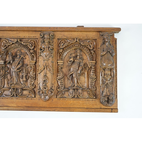 52 - A 17th century and later Flemish carved oak panel with three arched sections carved with the three v... 