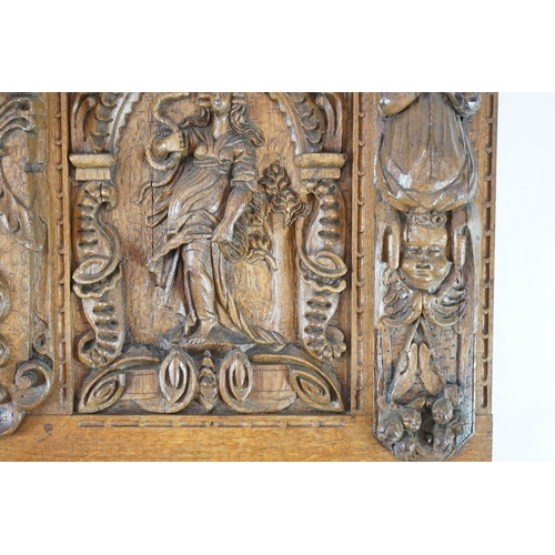 52 - A 17th century and later Flemish carved oak panel with three arched sections carved with the three v... 