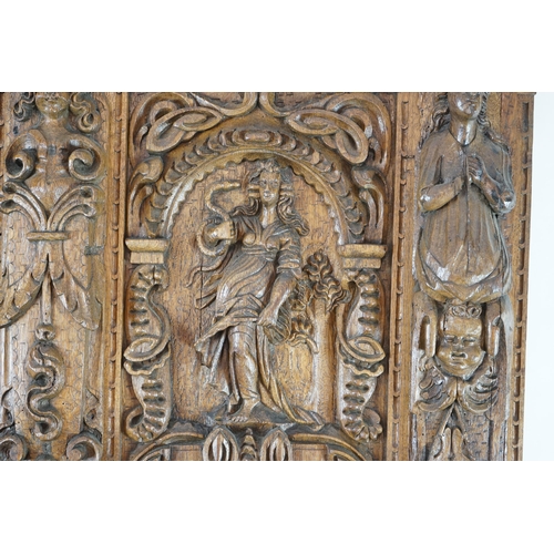 52 - A 17th century and later Flemish carved oak panel with three arched sections carved with the three v... 