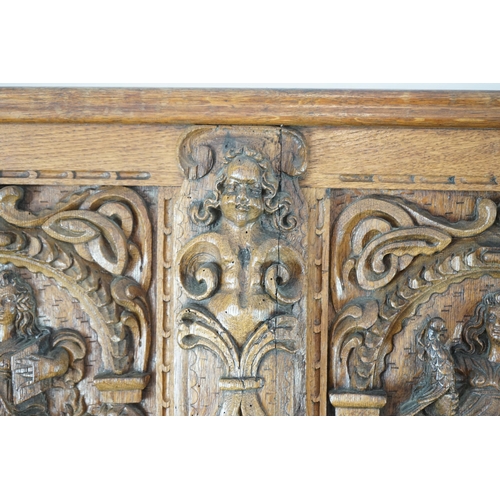 52 - A 17th century and later Flemish carved oak panel with three arched sections carved with the three v... 