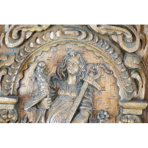 52 - A 17th century and later Flemish carved oak panel with three arched sections carved with the three v... 