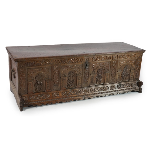 55 - A mid 18th century German carved oak marriage chest with single planked lid, the frieze, initialled ... 