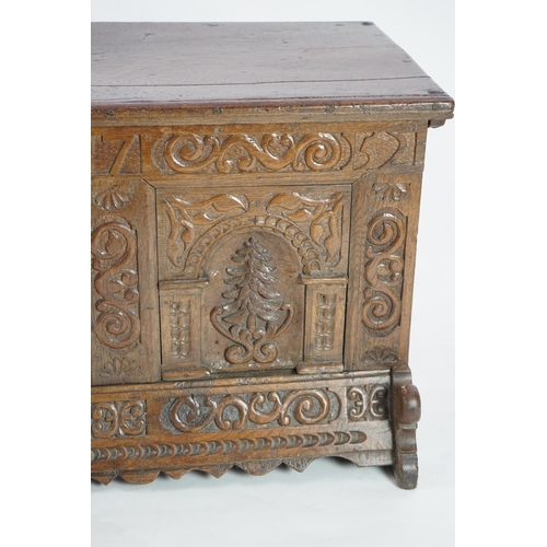 55 - A mid 18th century German carved oak marriage chest with single planked lid, the frieze, initialled ... 