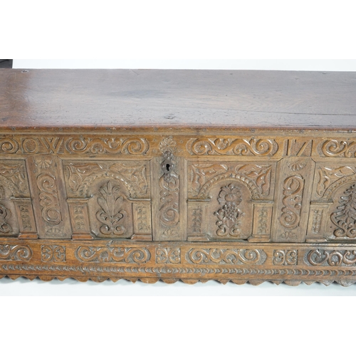 55 - A mid 18th century German carved oak marriage chest with single planked lid, the frieze, initialled ... 