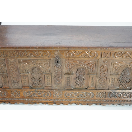 55 - A mid 18th century German carved oak marriage chest with single planked lid, the frieze, initialled ... 