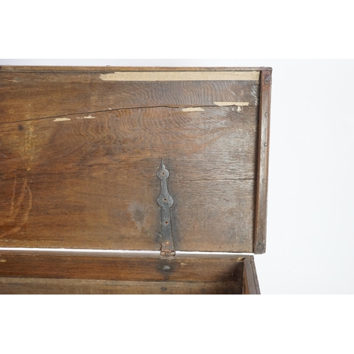 55 - A mid 18th century German carved oak marriage chest with single planked lid, the frieze, initialled ... 