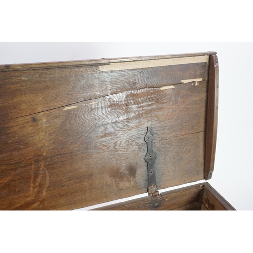 55 - A mid 18th century German carved oak marriage chest with single planked lid, the frieze, initialled ... 