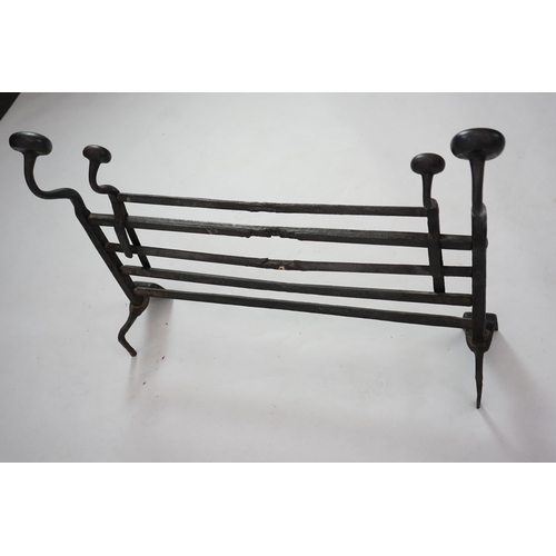 56 - A 17th century French iron adjustable grate with roundel finials and stylised scroll feet, 89cm wide... 