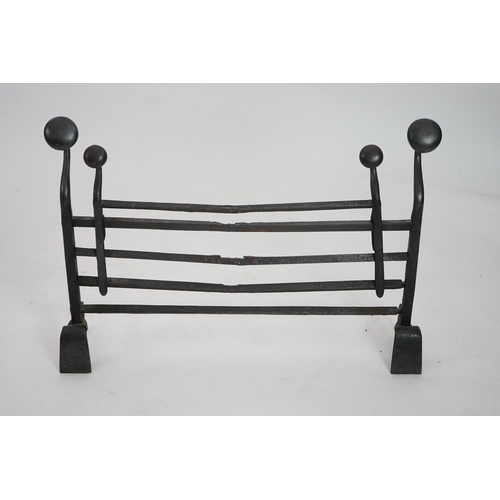 56 - A 17th century French iron adjustable grate with roundel finials and stylised scroll feet, 89cm wide... 