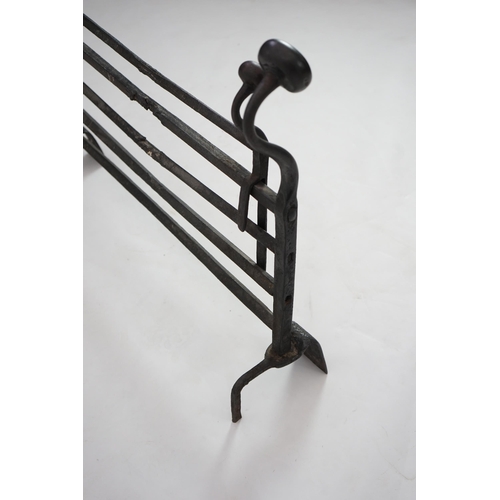 56 - A 17th century French iron adjustable grate with roundel finials and stylised scroll feet, 89cm wide... 