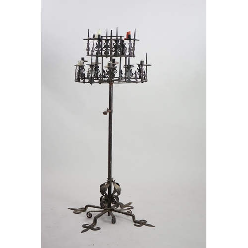 57 - A 17th century French wrought iron pricket candelabrum, the revolving circular two tier top with ten... 