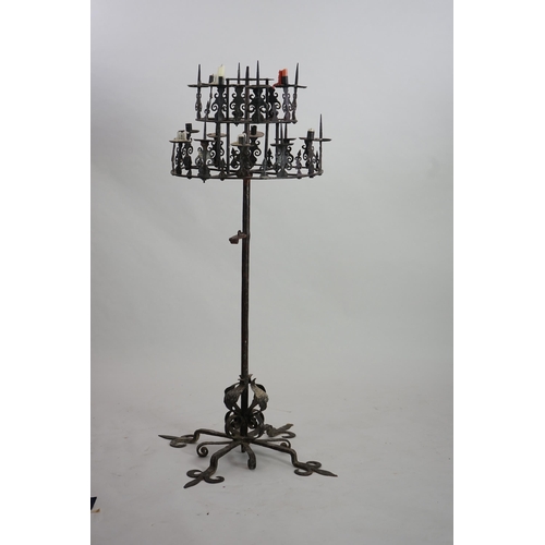 57 - A 17th century French wrought iron pricket candelabrum, the revolving circular two tier top with ten... 