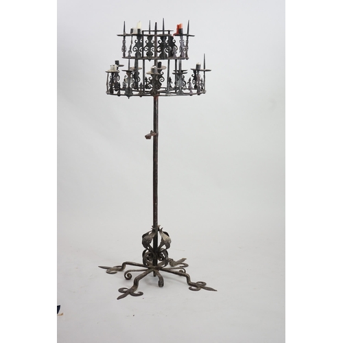 57 - A 17th century French wrought iron pricket candelabrum, the revolving circular two tier top with ten... 