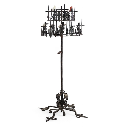 57 - A 17th century French wrought iron pricket candelabrum, the revolving circular two tier top with ten... 