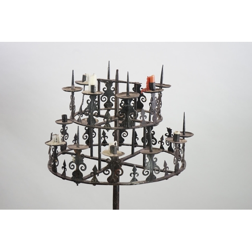 57 - A 17th century French wrought iron pricket candelabrum, the revolving circular two tier top with ten... 