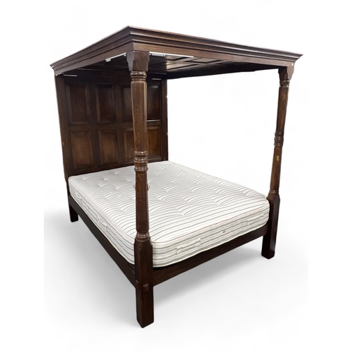 59 - A 17th century style oak full tester bedstead with moulded cornice, panelled headboard and turned fr... 