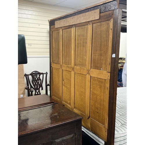 59 - A 17th century style oak full tester bedstead with moulded cornice, panelled headboard and turned fr... 