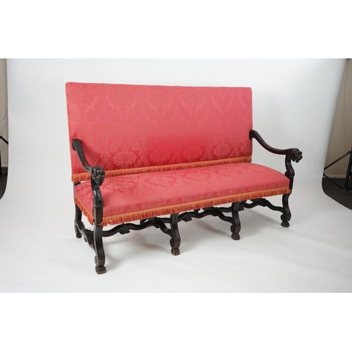 6 - A 17th century style walnut settee with upholstered back and seat, acanthus carved scroll arms with ... 