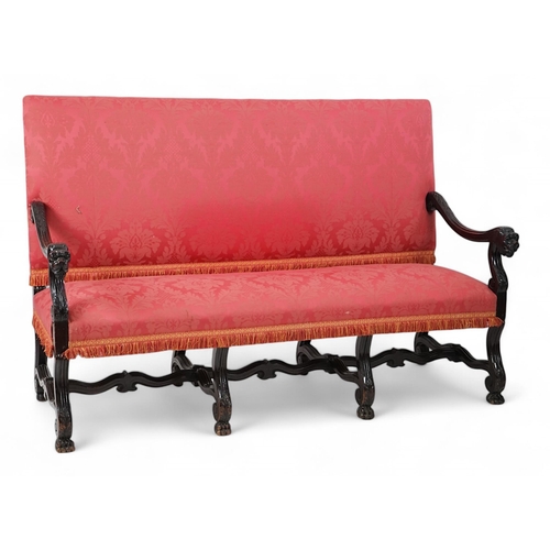 6 - A 17th century style walnut settee with upholstered back and seat, acanthus carved scroll arms with ... 