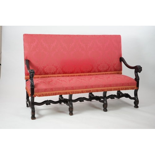 6 - A 17th century style walnut settee with upholstered back and seat, acanthus carved scroll arms with ... 