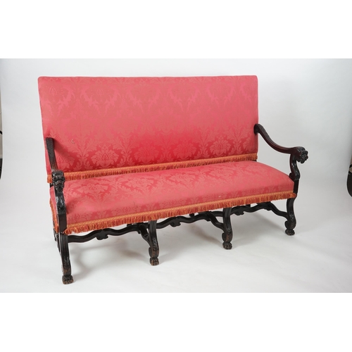 6 - A 17th century style walnut settee with upholstered back and seat, acanthus carved scroll arms with ... 