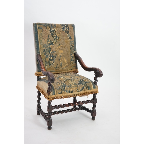 60 - A 17th century French walnut fauteuil with verdure tapestry upholstery, the back depicting a mother ... 