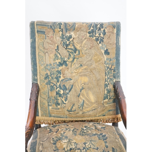 60 - A 17th century French walnut fauteuil with verdure tapestry upholstery, the back depicting a mother ... 