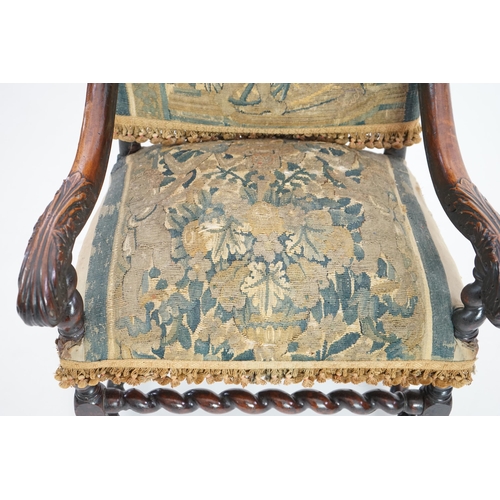 60 - A 17th century French walnut fauteuil with verdure tapestry upholstery, the back depicting a mother ... 