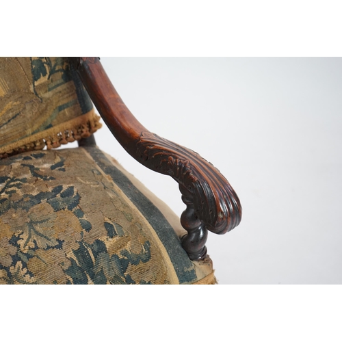 60 - A 17th century French walnut fauteuil with verdure tapestry upholstery, the back depicting a mother ... 