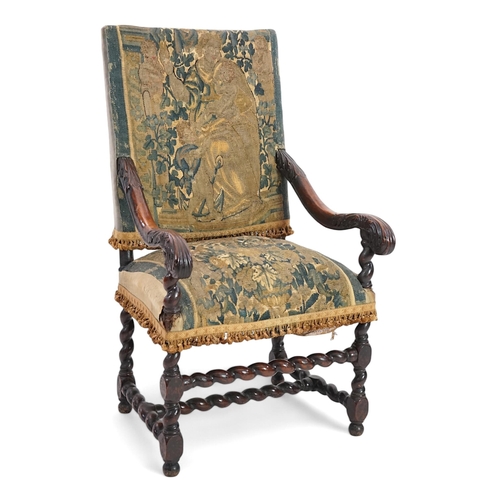 60 - A 17th century French walnut fauteuil with verdure tapestry upholstery, the back depicting a mother ... 